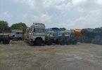 Big vehicles and trolleys coming from outside standing on the road