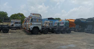 Big vehicles and trolleys coming from outside standing on the road