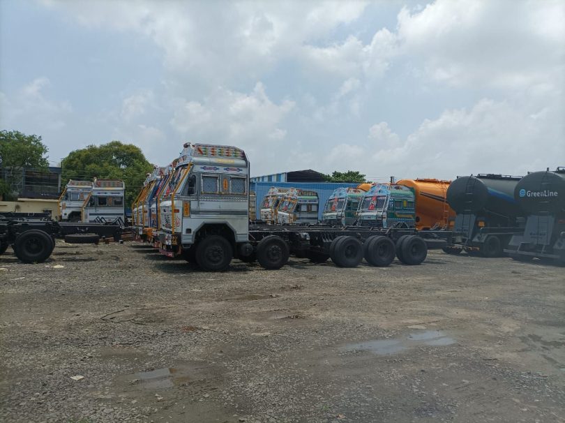 Big vehicles and trolleys coming from outside standing on the road